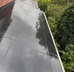 Finished flat roof surface on a residential extension after rainfall