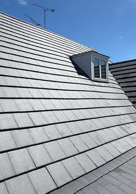 Tiled pitched roof with a dormer window on a residential property